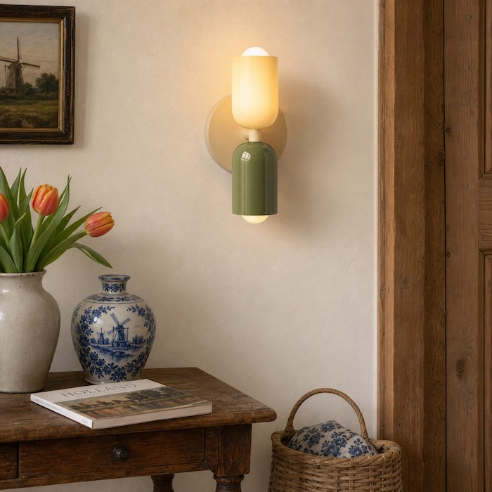 Modern wall sconce coordinated with wood, matte paint, and soft textiles.