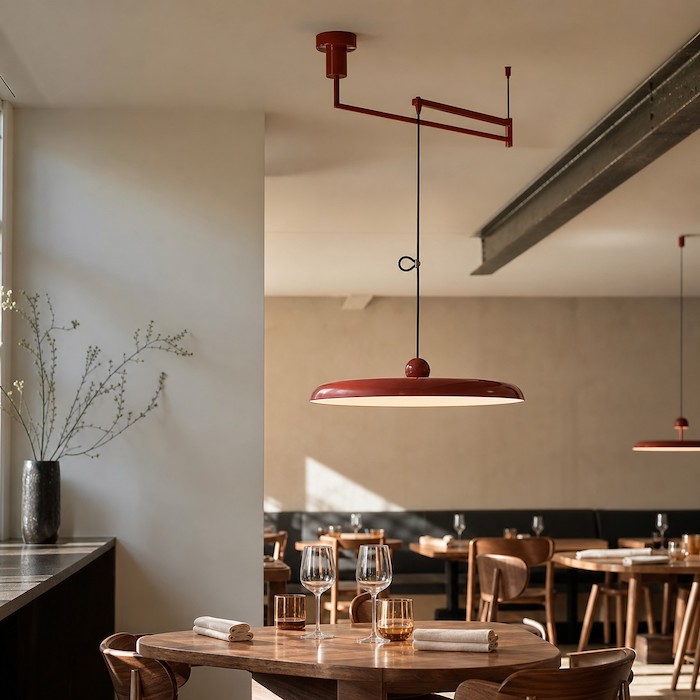 Minimal disc swing arm pendant adding flexibility without visual clutter.