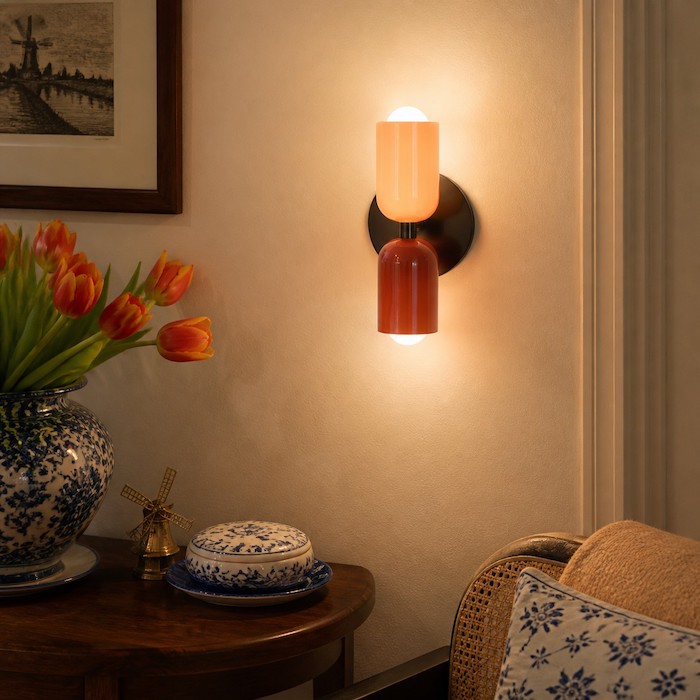 Up-and-down wall light creating vertical layers on a plain wall.