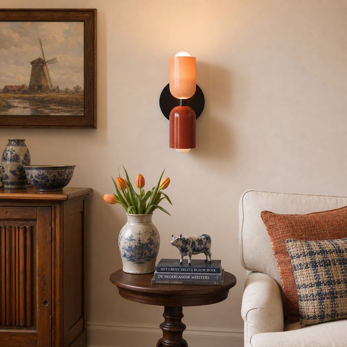 Living room wall sconce height balanced with sofa and artwork.