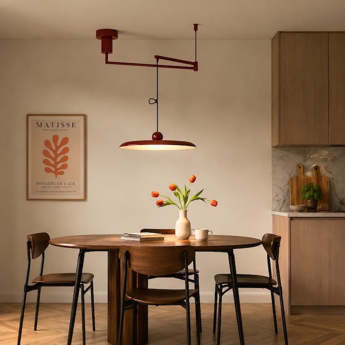 Swing-arm pendant centred over one priority table in a compact dining room.