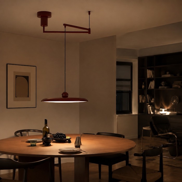 Eye-level dining scene with an adjustable pendant reaching an off-centre table.
