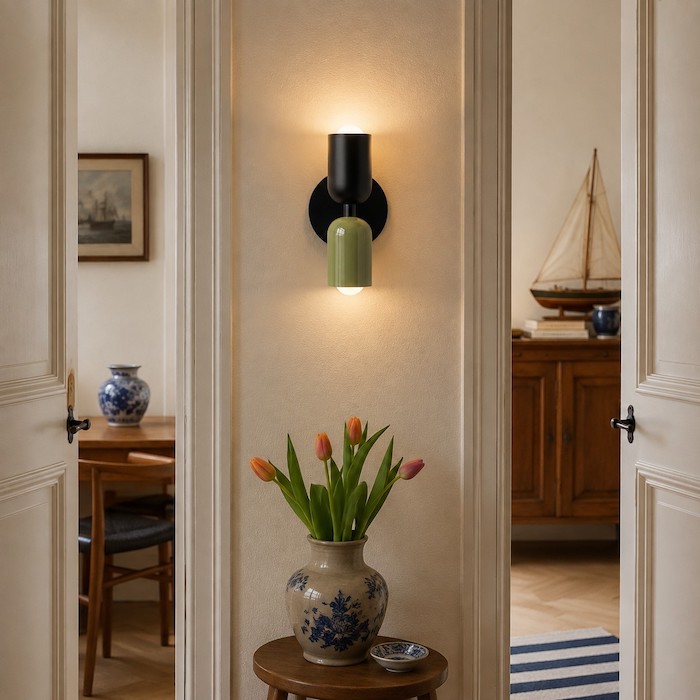 Single wall sconce completing a small wall between two doorways.