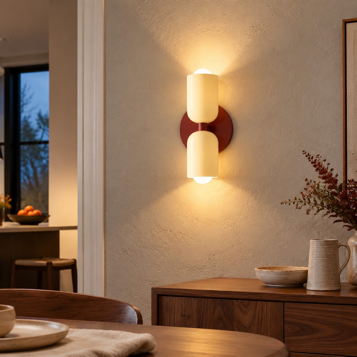 Dual-direction wall light grazing a textured plaster wall above a walnut cabinet.