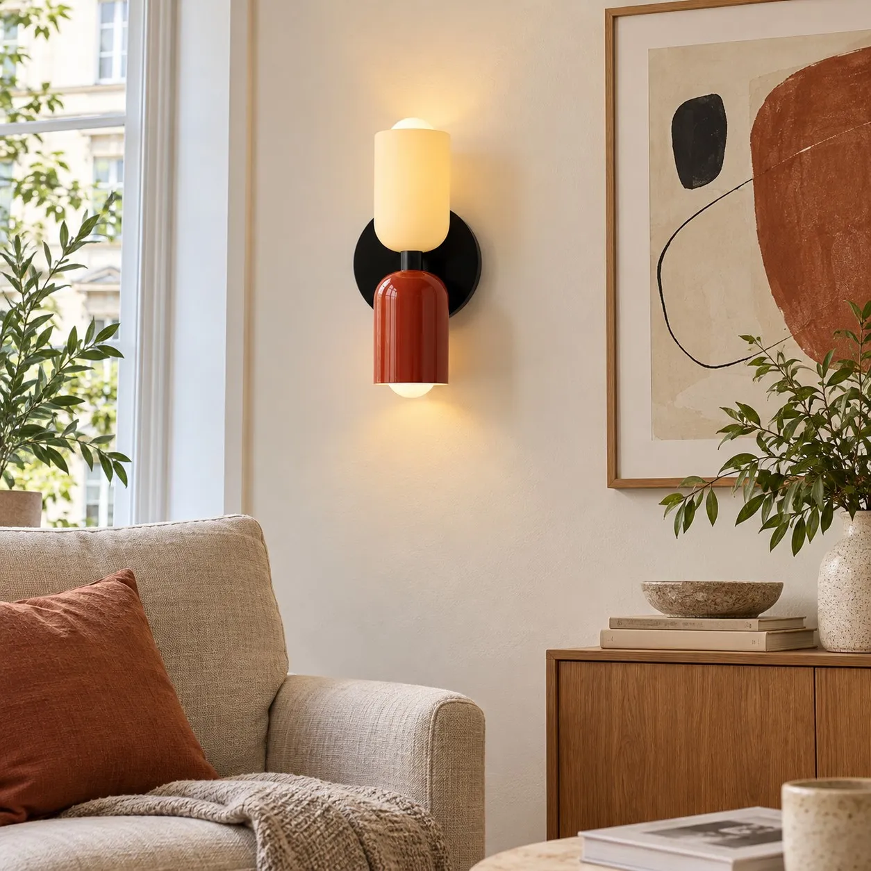 Quiet living-room composition with a modern wall lamp beside one framed artwork and a linen chair