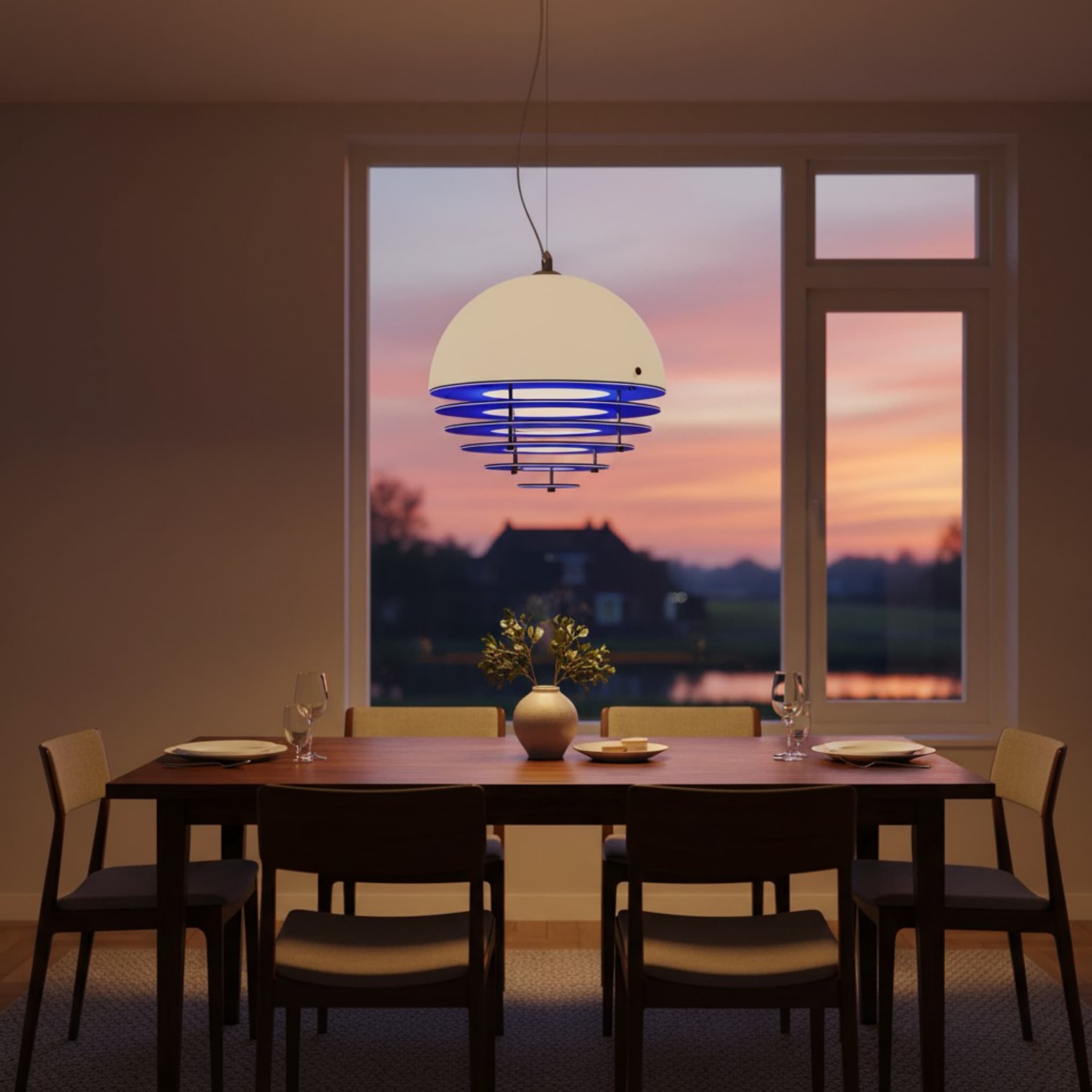 Klein blue Bauhaus Sunset Pendant Lamp above a dining table at dusk
