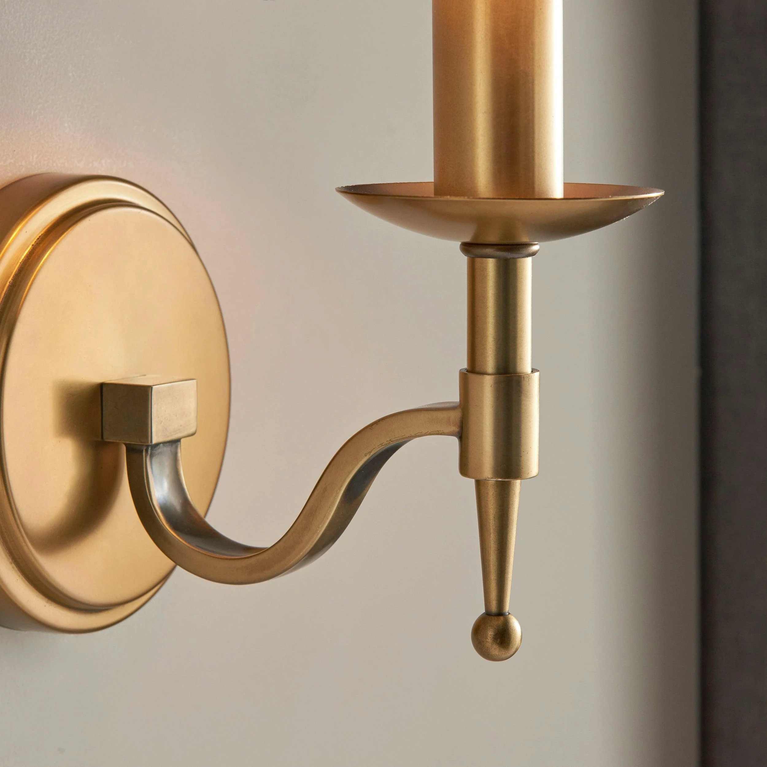 Close-up of Tela curved brass arm detail