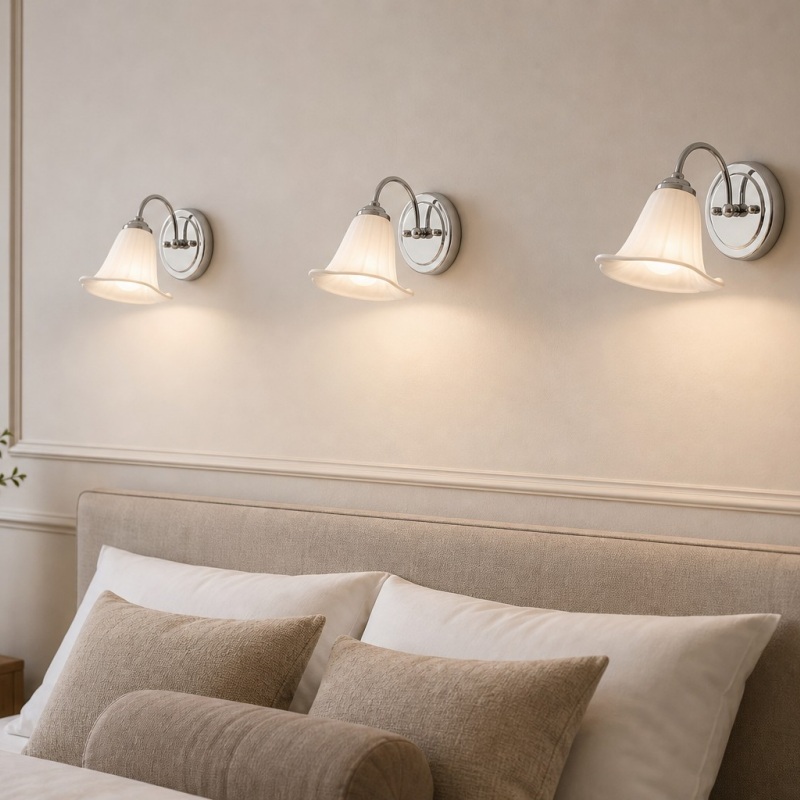 Multiple calla lily wall lamps above a bed
