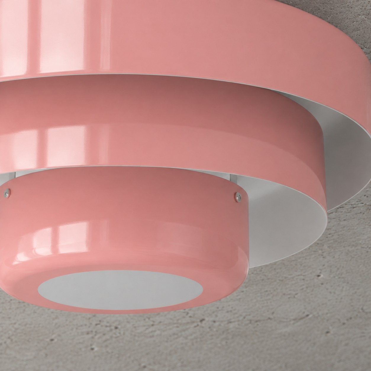 Close view of the pink Malero lamp's three curved metal layers