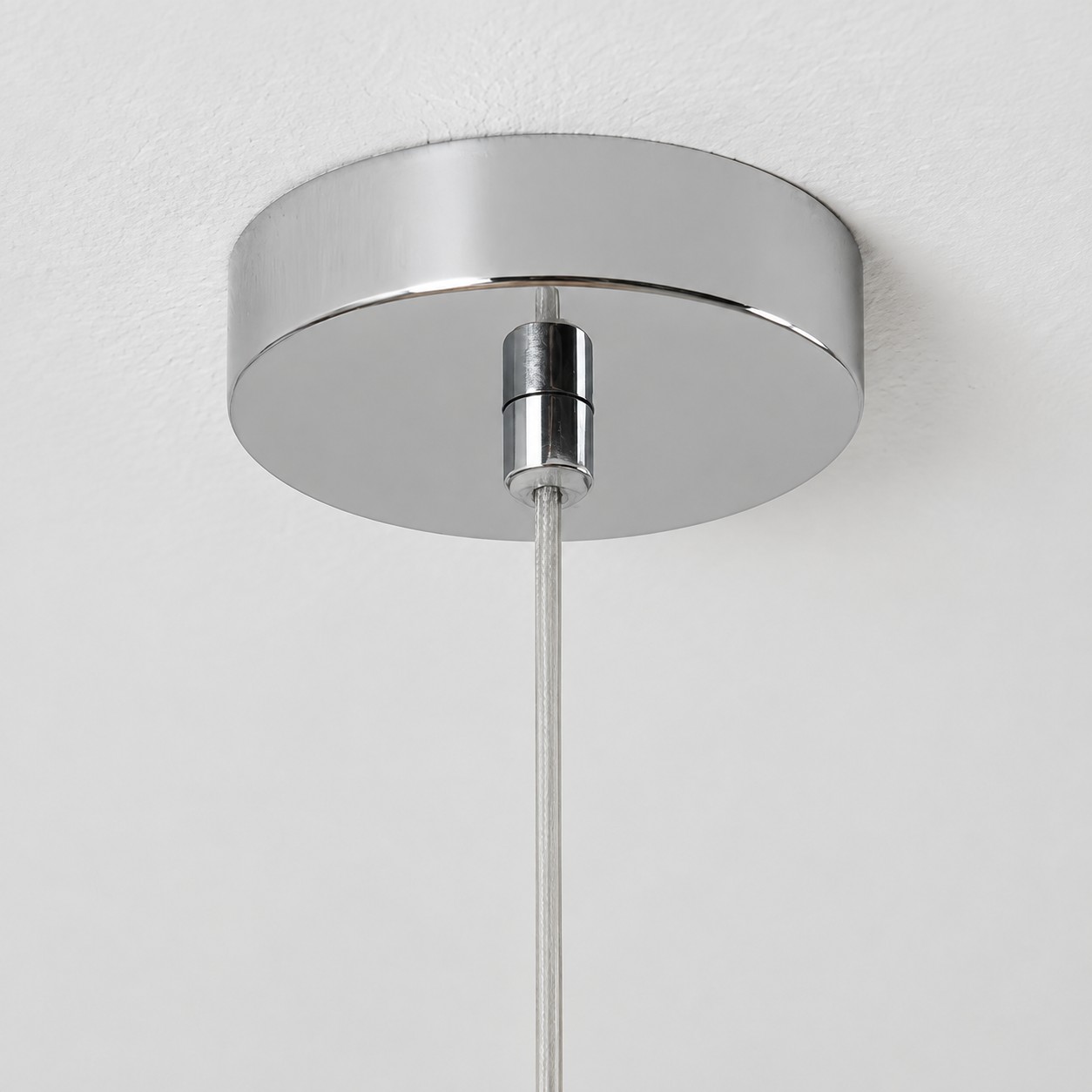 Polished ceiling canopy and clear suspension cable