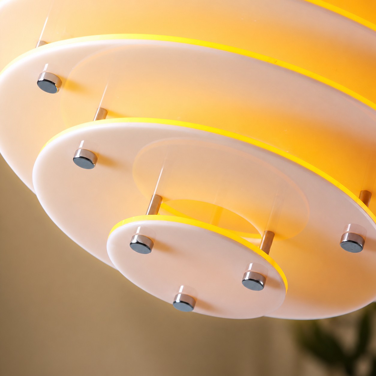 Close-up of layered acrylic rings and metal fittings