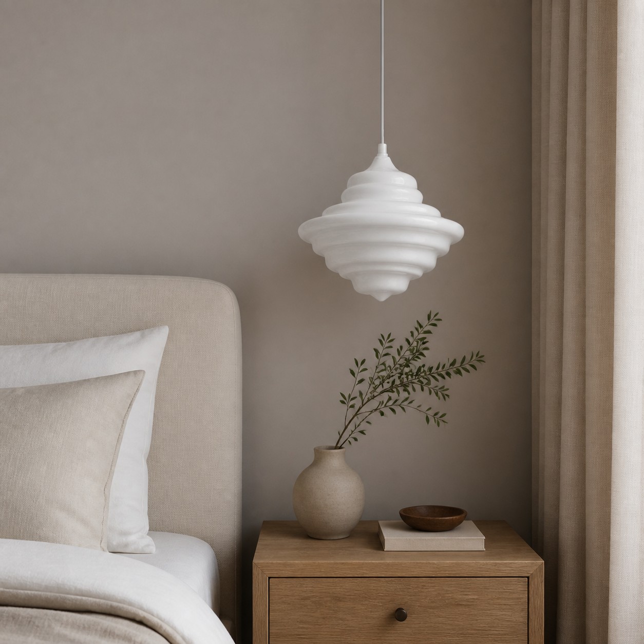One white glass pendant beside a bed