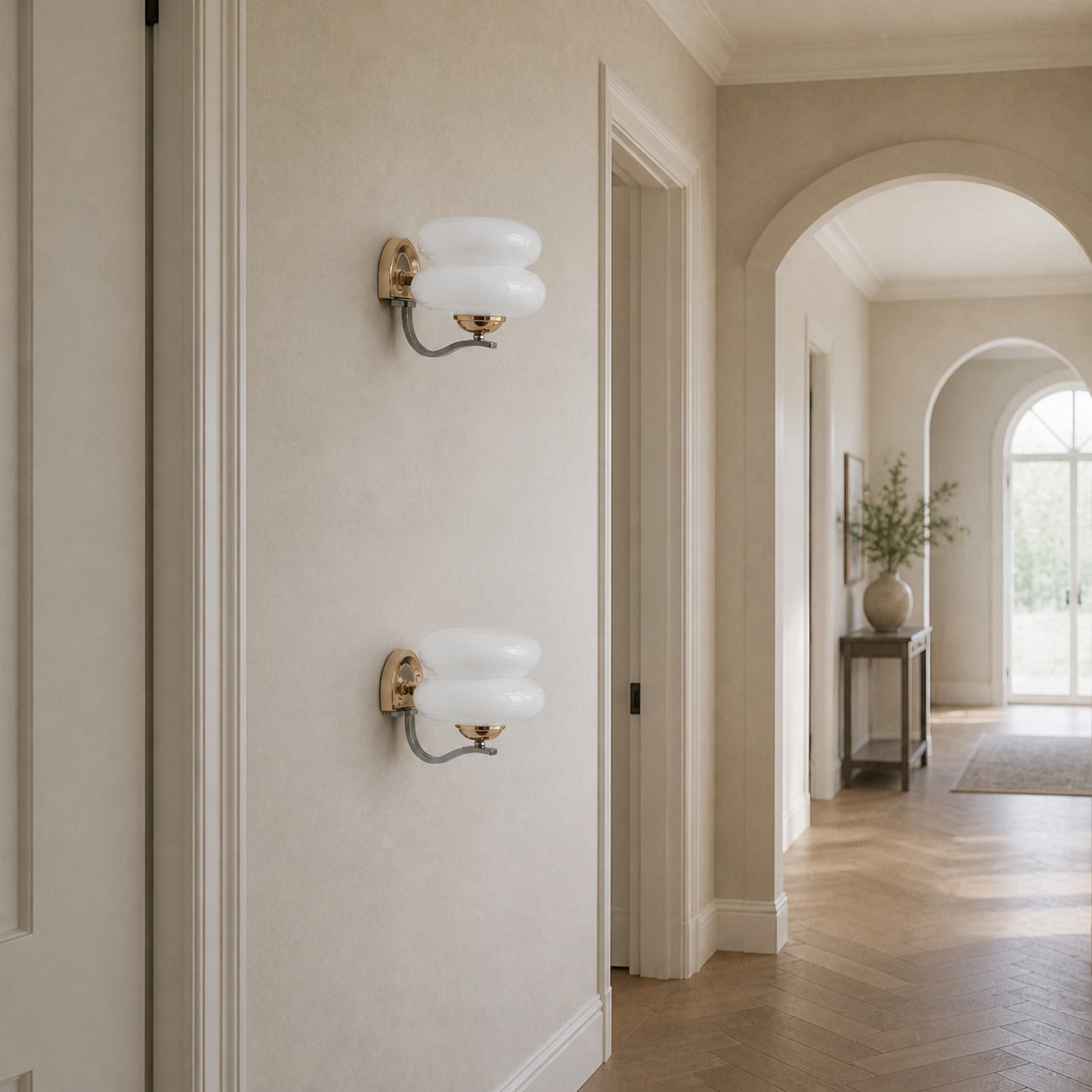 Ivory single-head wall sconces along a hallway