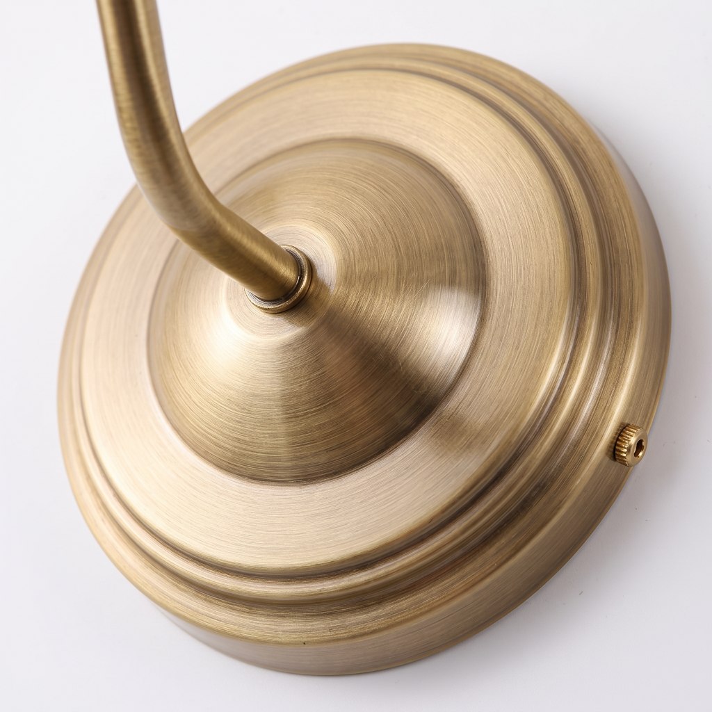Brushed brass-tone round wall plate detail