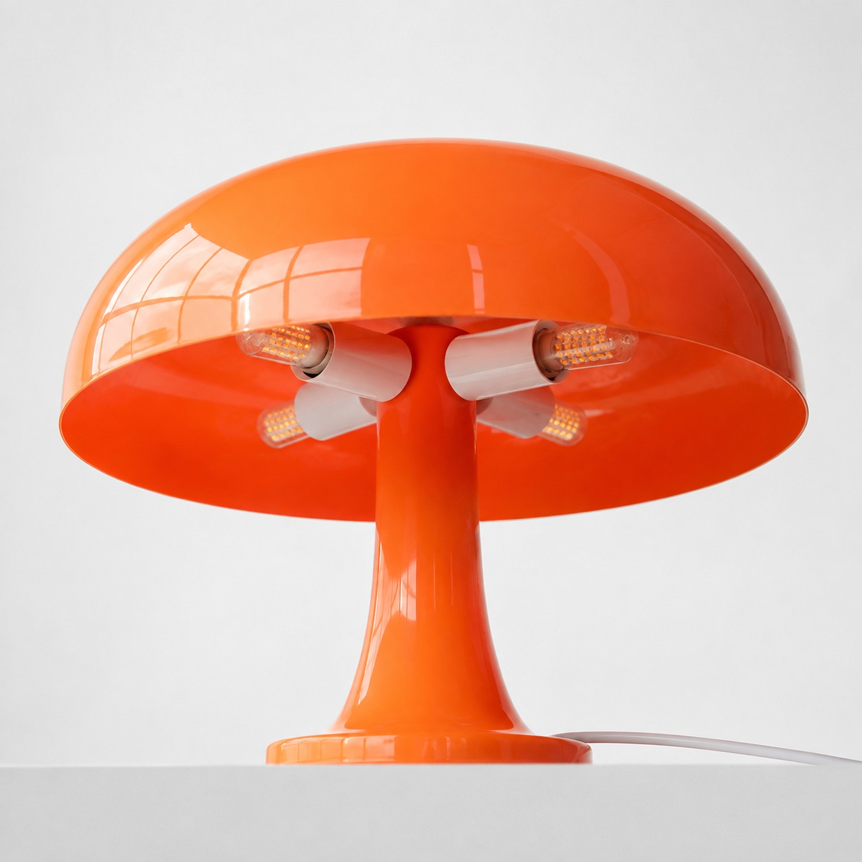 Underside of the orange shade with four E14 bulb fittings