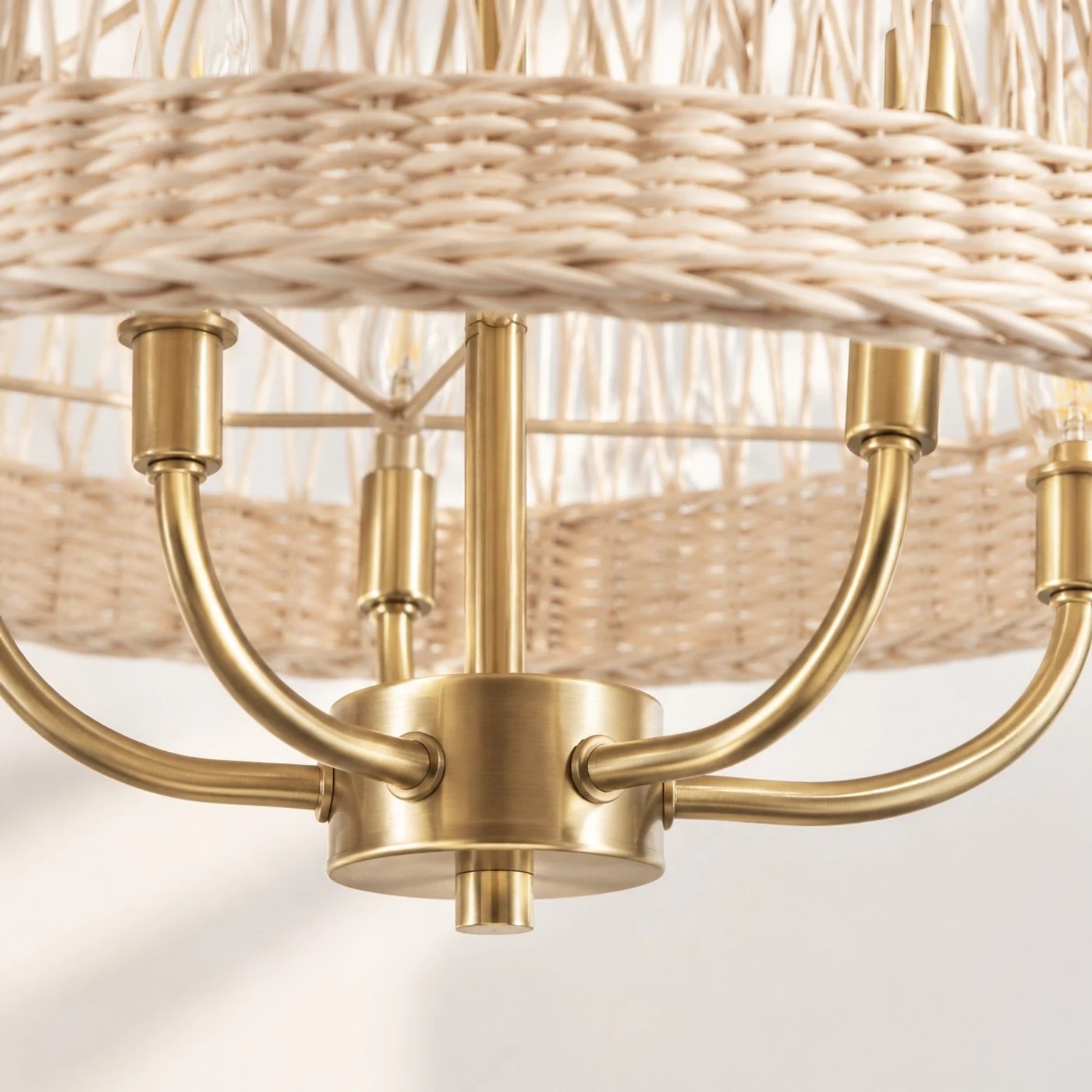 Close detail of brass-gold chandelier arms and candle sockets